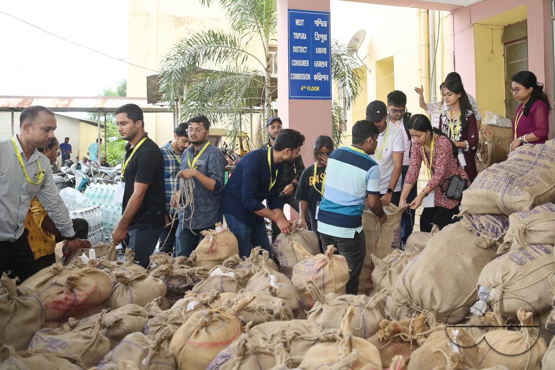 Government officials and workers are preparing food packets to be distributed by NDRF (National Disaster Response Force) personnel from helicopters to flood victims in different parts of Tripura