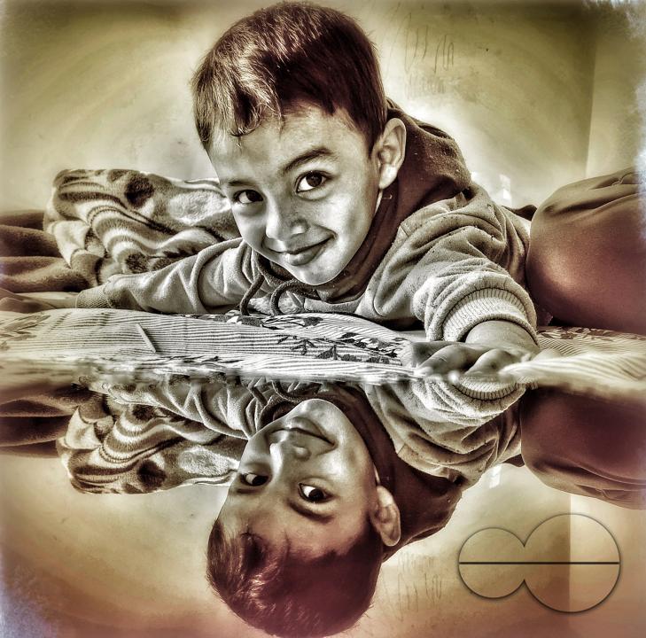 A beautiful mirrored painting of a smiling child