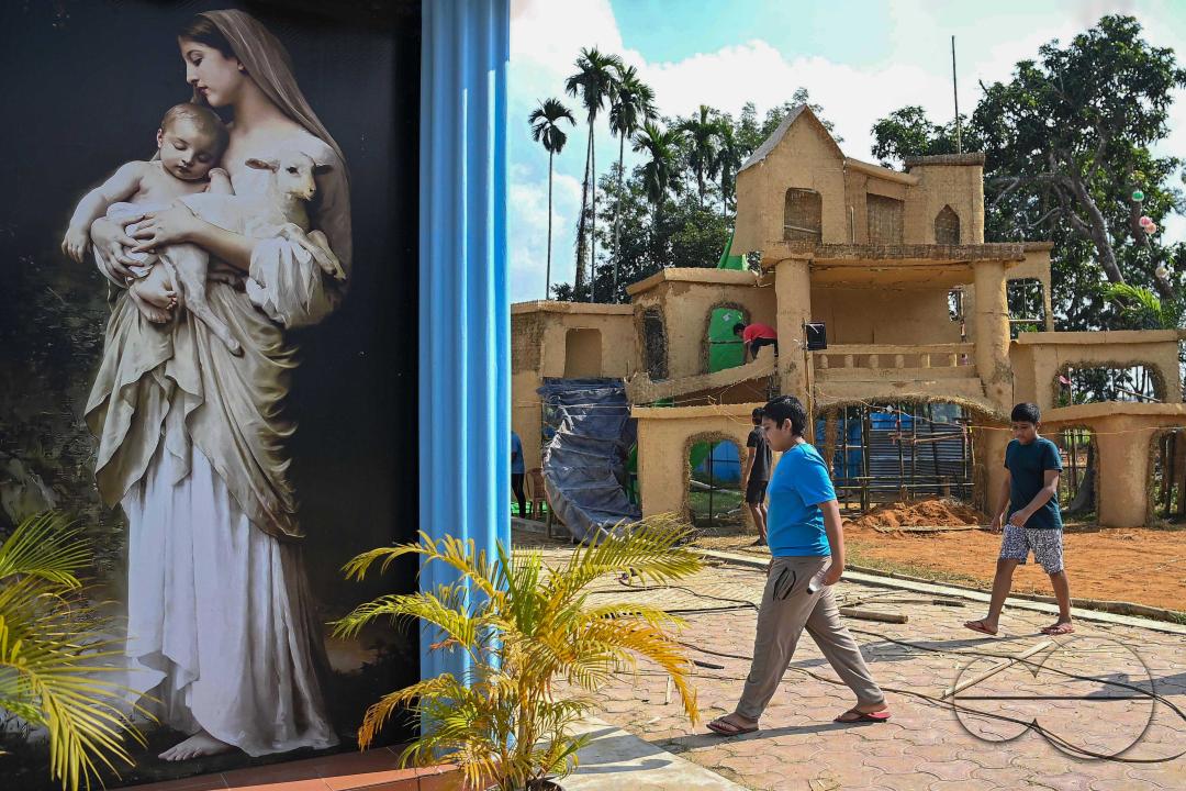 People decorate a church in preparation for Christmas Day at Mariam Church, Agartala