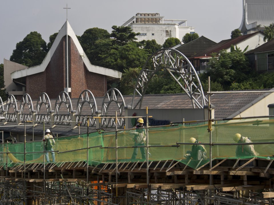 Migrant workers at a construction site by a highway in Singapore