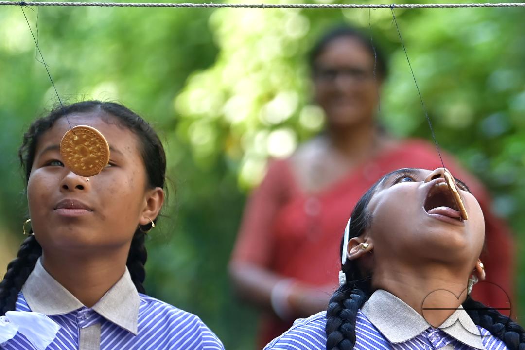 Students at the Institute for Visually Handicapped are participating in a 'Biscuit Race' during the 'Children's Day' celebration at the institute's campus in Narsingarh, in Agartala