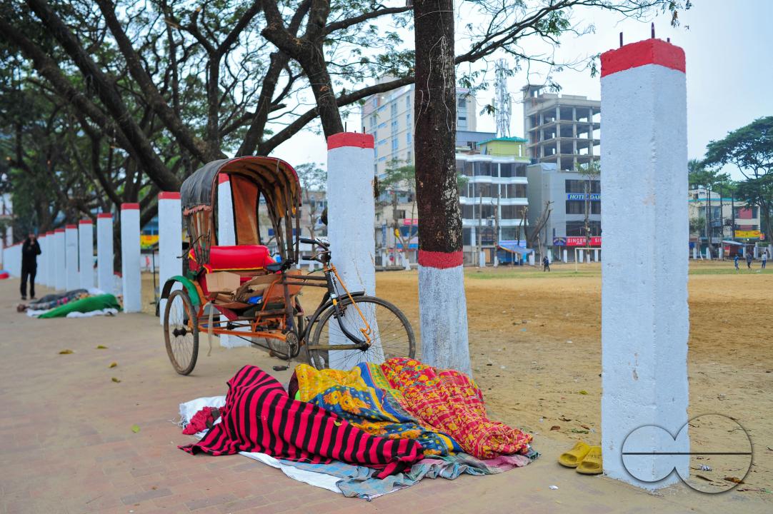 Covering their bodies from head to toe with whatever they can manage, homeless people sleep out in the open in the shivering cold near the Government Alia Madrasa in Sylhet city's Chowhatta area