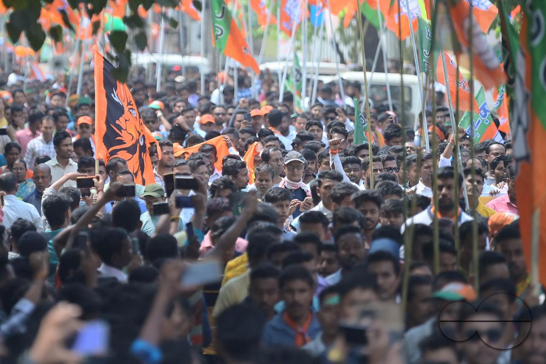 BJP supporters seen in a rally with Tripura Chief Minister Manik Saha, former CM and BJP candidate Biplab Kumar Deb, and Kriti Singh along with other leaders during an election campaign rally in support of Lok Sabha candidates at Agartala