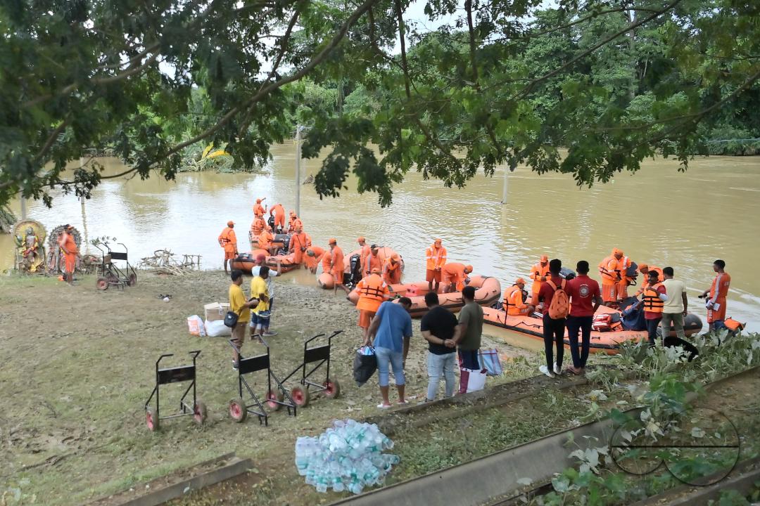 NDRF (National Disaster Response Force) personnel are seen preparing themselves to rescue people from a flooded village in the outskirts of Amarpur city, 82km away from Agartala