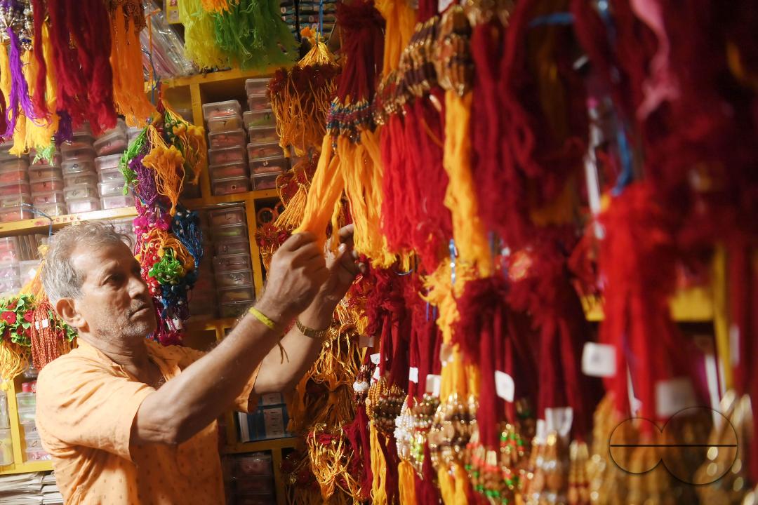 A shop owner arranging "Rakhi", sacred threads for the upcoming "Raksha Bandhan" festival at his shop in Agartala