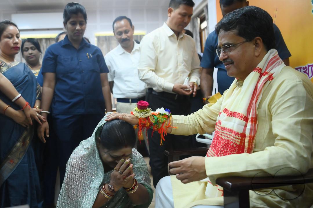 A lady getting a blessing from Tripura CM Professor Dr Manik Saha after tying rakhi to him at his official residence at Agartala
