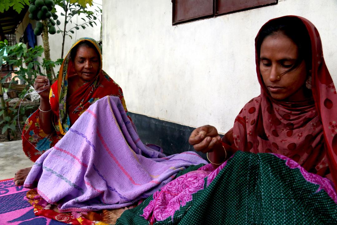 Rural Bangladeshi women sewing and embroidering bed sheets, pillow cases, rugs, table cloths and other household items which is their livelihood