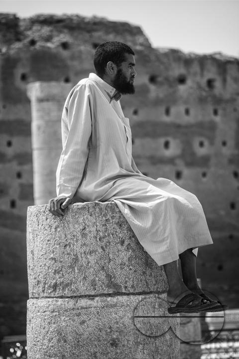 Tourists exploring the historic site of Hassan Tower