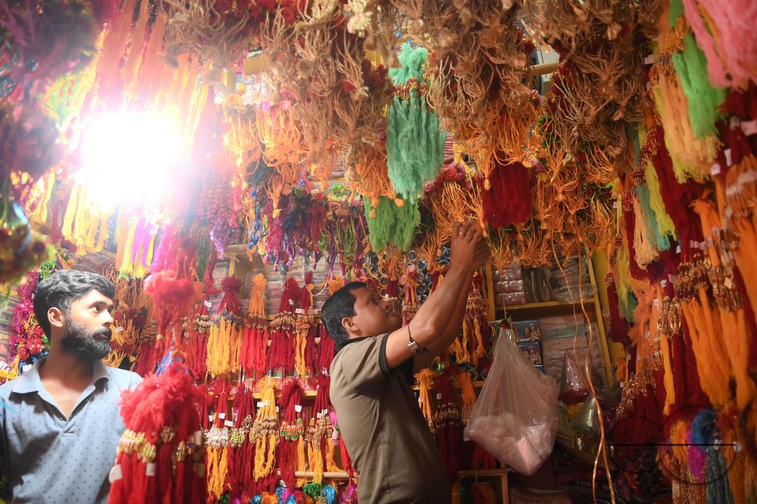 A shop owner arranging "Rakhi", sacred threads for the upcoming "Raksha Bandhan" festival at his shop in Agartala