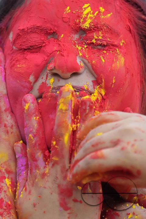 Indian girls adorned with 'Gulal' or coloured powder during the Hindu spring festival 'Holi', the festival of colour in Agartala