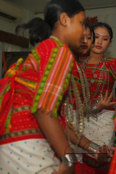 Indigenous girls perform traditional dances on the occasion of World Indigenous Day in an auditorium at Agartala