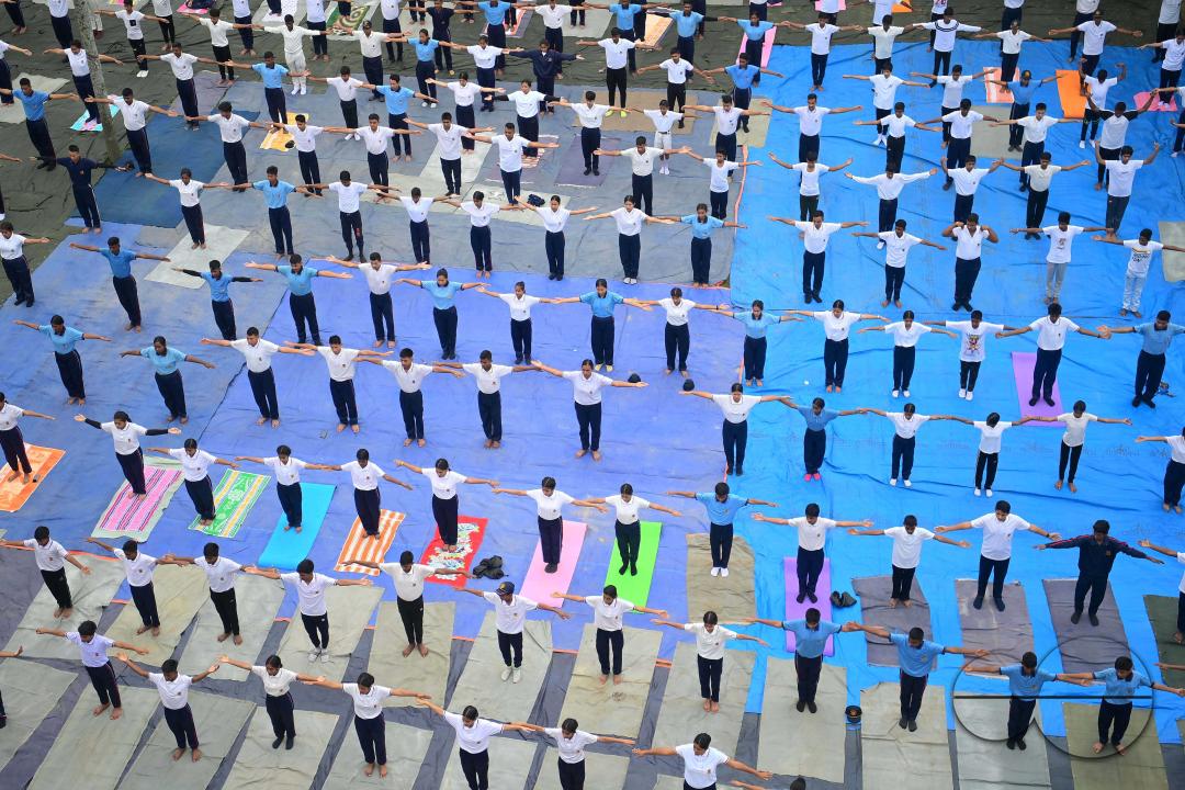 NCC cadets and officials perform yoga during 10th International Day of Yoga Day at BBM College Ground in Agartala