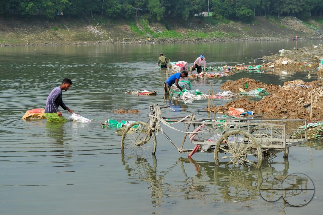 Women are risking their lives to wash cement bags beside the Surma River in Sylhet