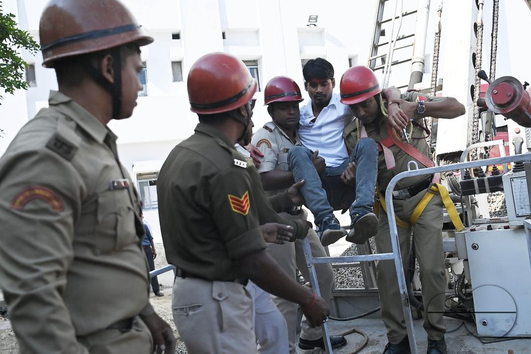 Fire brigade personnel are trying to control a fire on the top of the building of the dental college during a state level mock exercise on earthquake day at Agartala