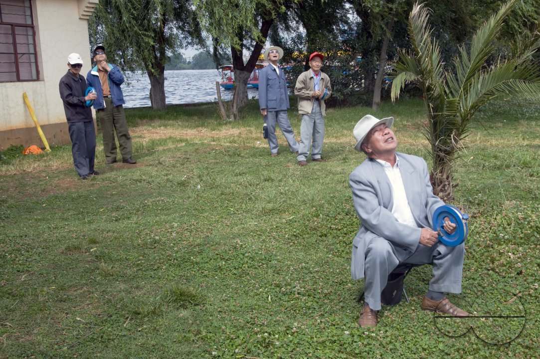 CHINA Elderly people flying kites in a park in Kunming, Yunnan province..