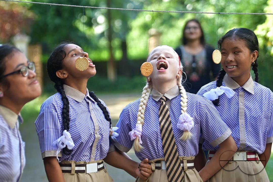 Students at the Institute for Visually Handicapped are participating in a 'Biscuit Race' during the 'Children's Day' celebration at the institute's campus in Narsingarh, in Agartala