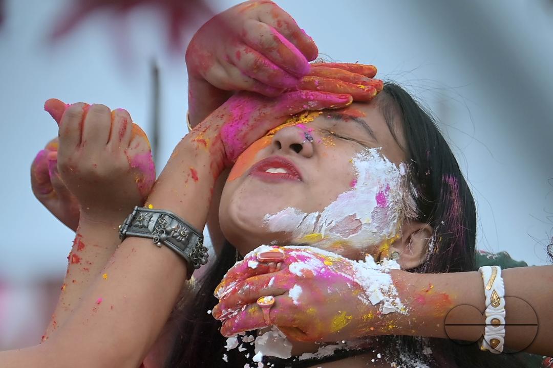Indian girls adorned with 'Gulal' or coloured powder during the Hindu spring festival 'Holi', the festival of colour in Agartala