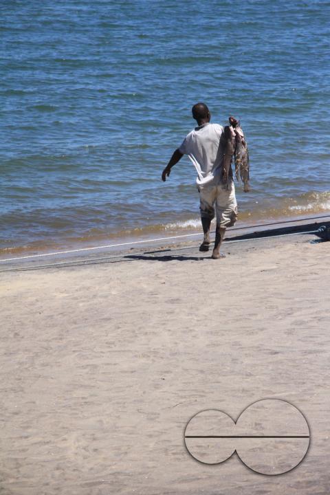 A fish vendor is seen on the shores of Lake Malawi, Senga Bay, Salima