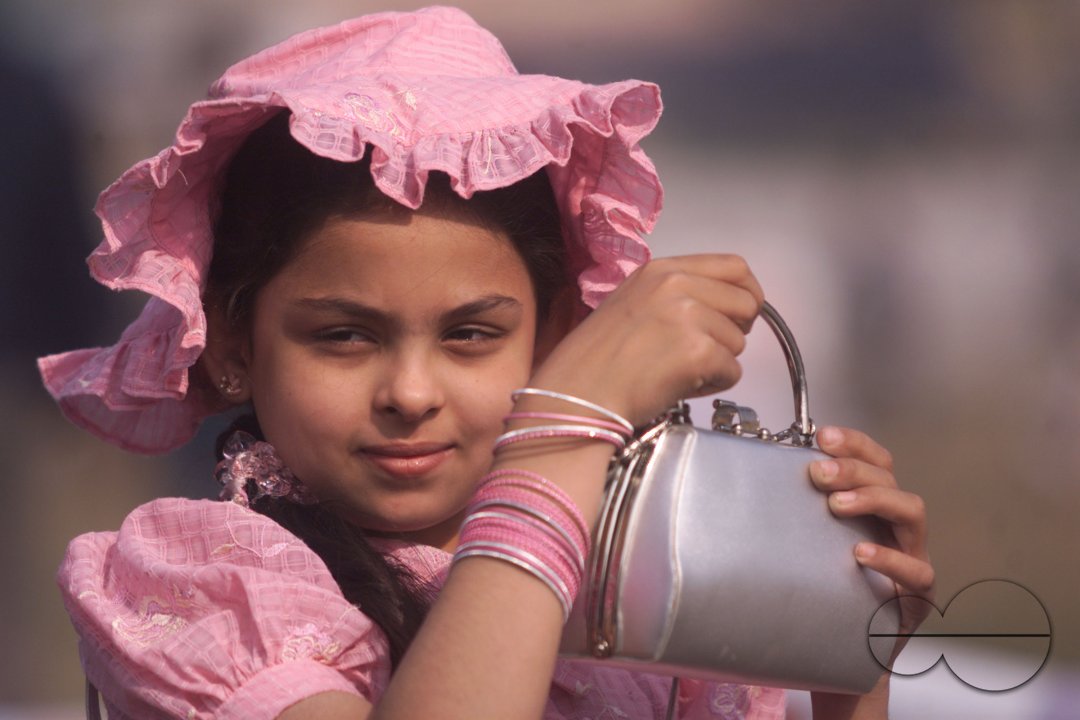 An Indian girl poses during vintage car rally in Kolkata