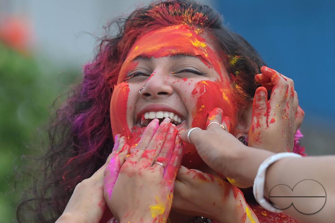 Indian girls adorned with 'Gulal' or coloured powder during the Hindu spring festival 'Holi', the festival of colour in Agartala