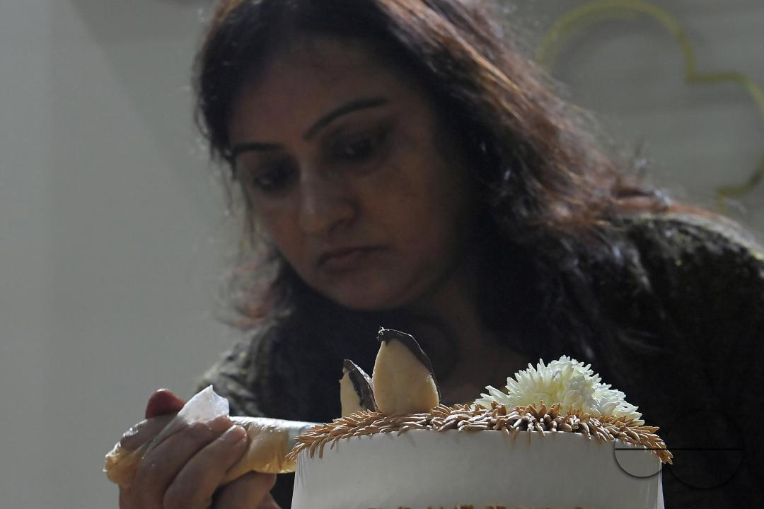 Sutapa Choudhary, a cake artist and teacher, making cakes at her cake parlour, "CREAMY DELIGHTS"