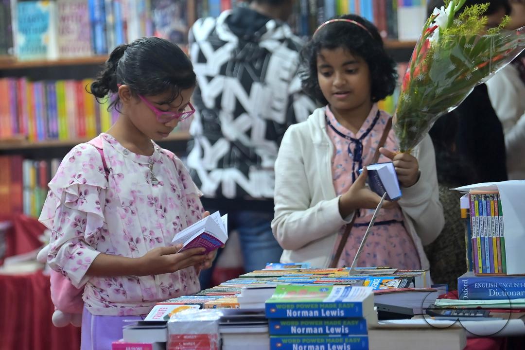 Children looking at books in a book stall at the 42nd Agartala Book fair International Fair Ground, Hapania at Agartala