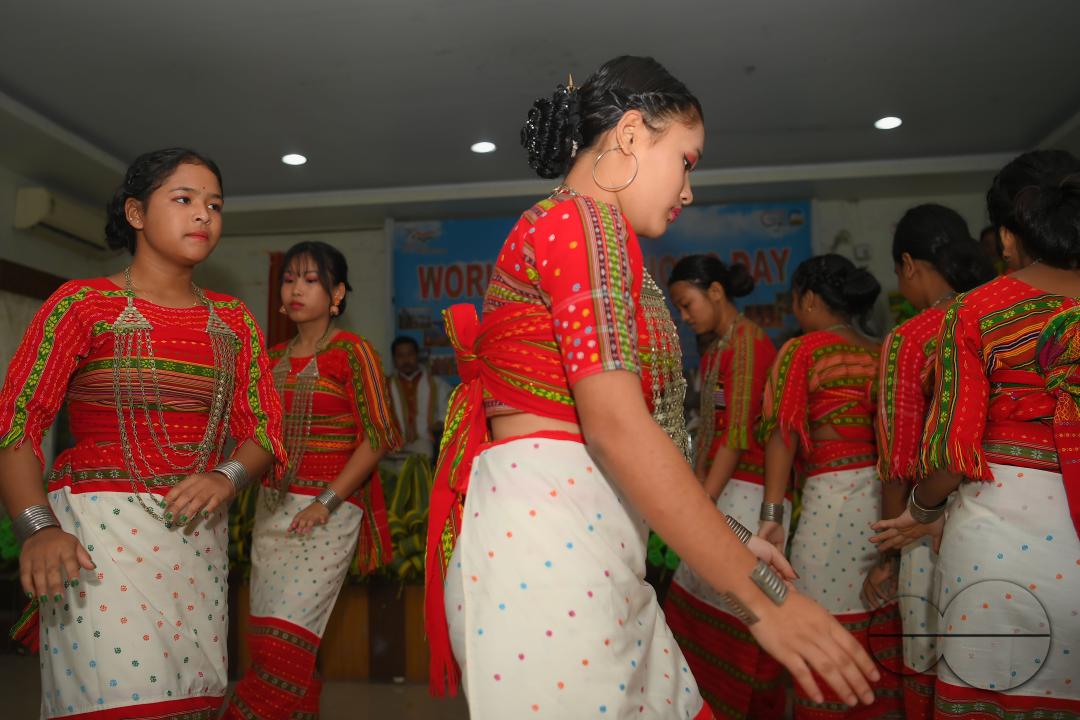 Indigenous girls perform traditional dances on the occasion of World Indigenous Day in an auditorium at Agartala