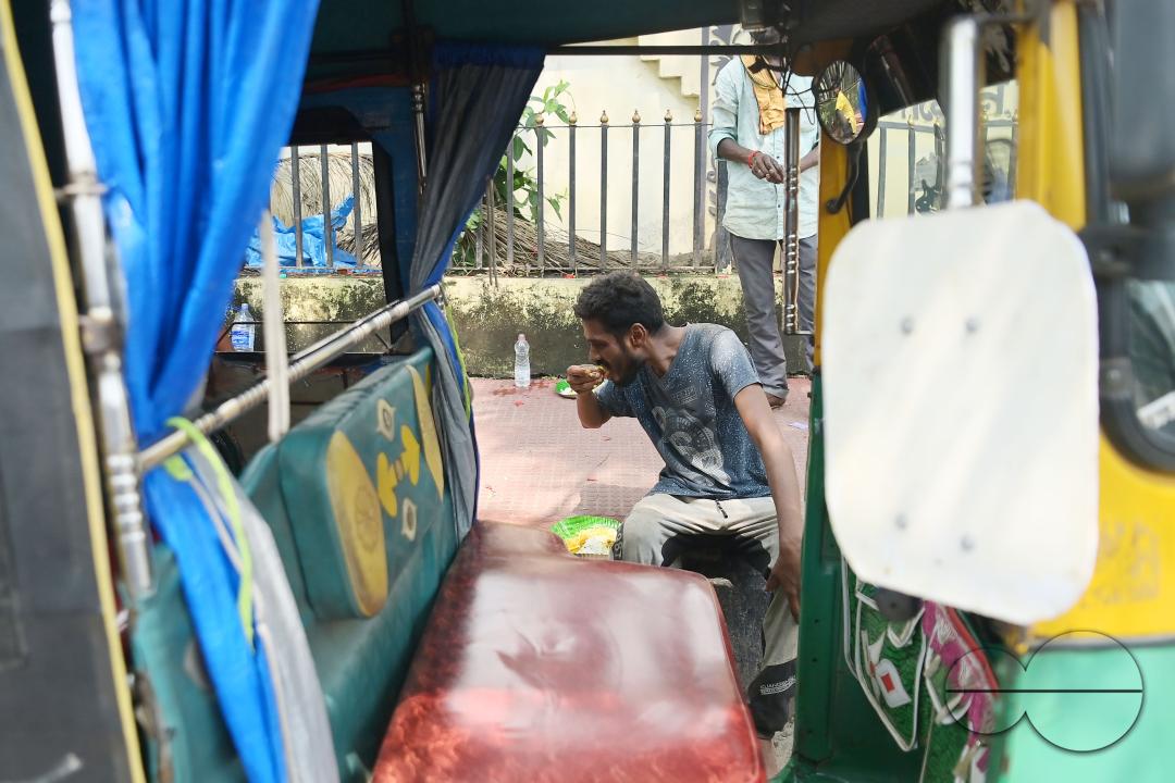 An auto driver eats food distributed by a social worker on World Food Safety Day organised by Rotary Club of Agartala, in Agartala