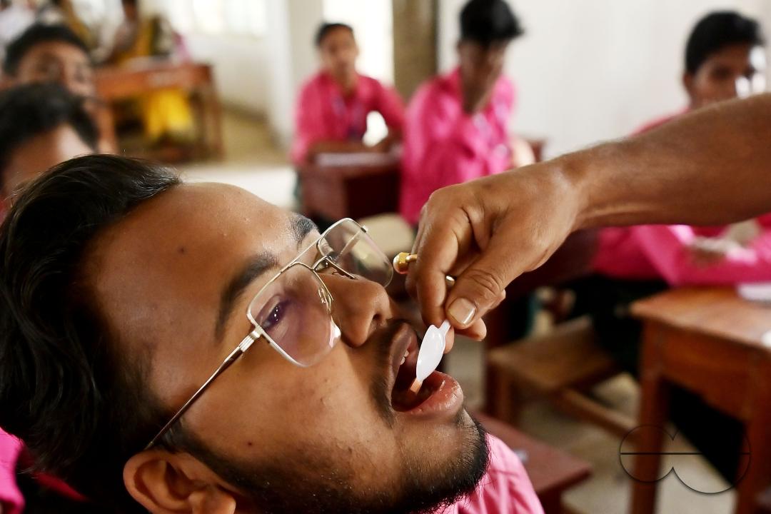 A student of Netaji Subhash Vidyaniketan High School is taking a deworming tablet during the special program "Mukhyamantri Sustho Shoishob, Sustho Kaishore Abhiyan (MSSSKA 7.0)" in Agartala