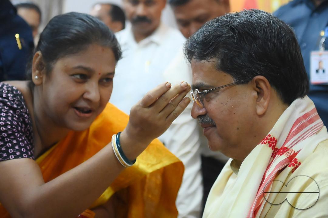 A lady tying rakhi and doing other rituals to Tripura CM Professor Dr