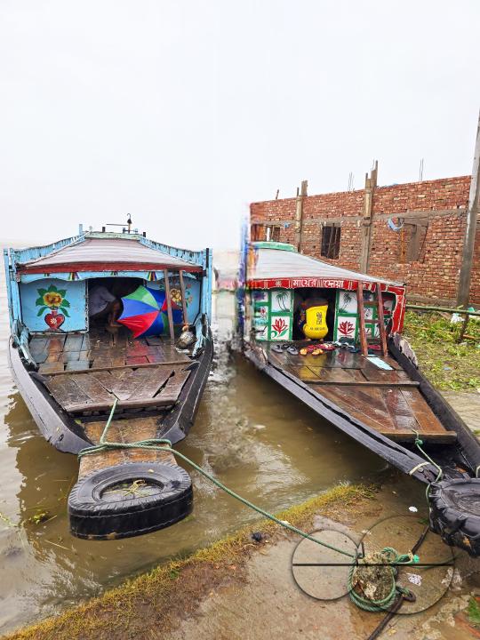 Two launches, used for ferrying passengers and goods, berthed at the shore of Dingapotha, Mohonganj âhaorâ (a large body of wetland formed by river and rain water, famous as a fishing area)