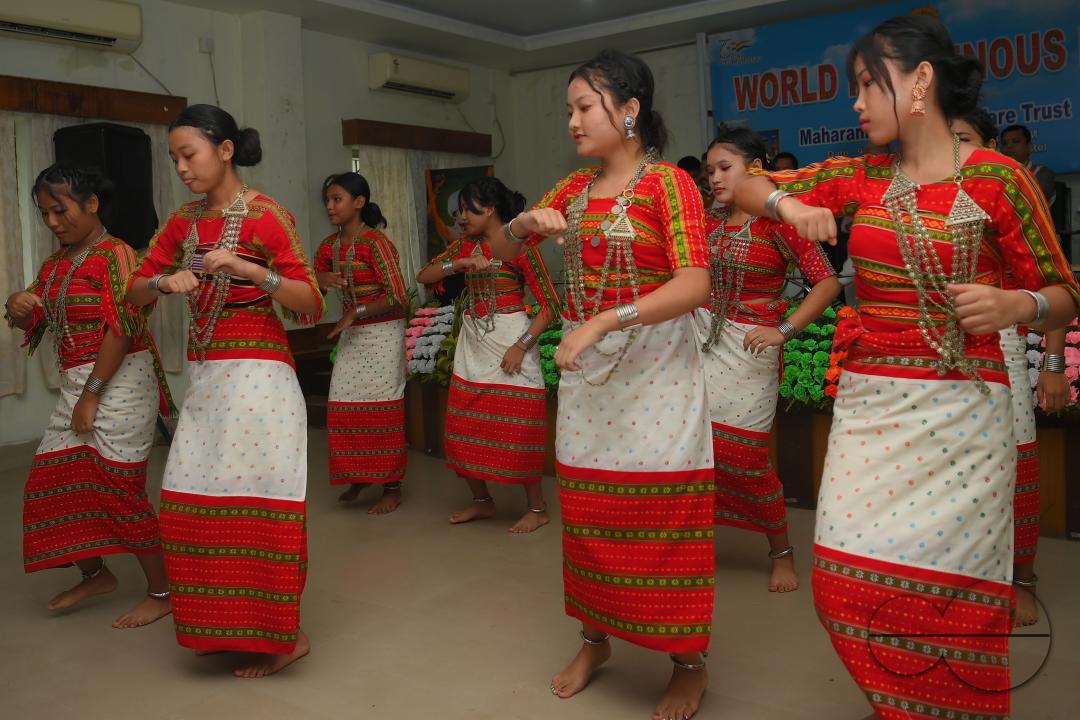Indigenous girls perform traditional dances on the occasion of World Indigenous Day in an auditorium at Agartala