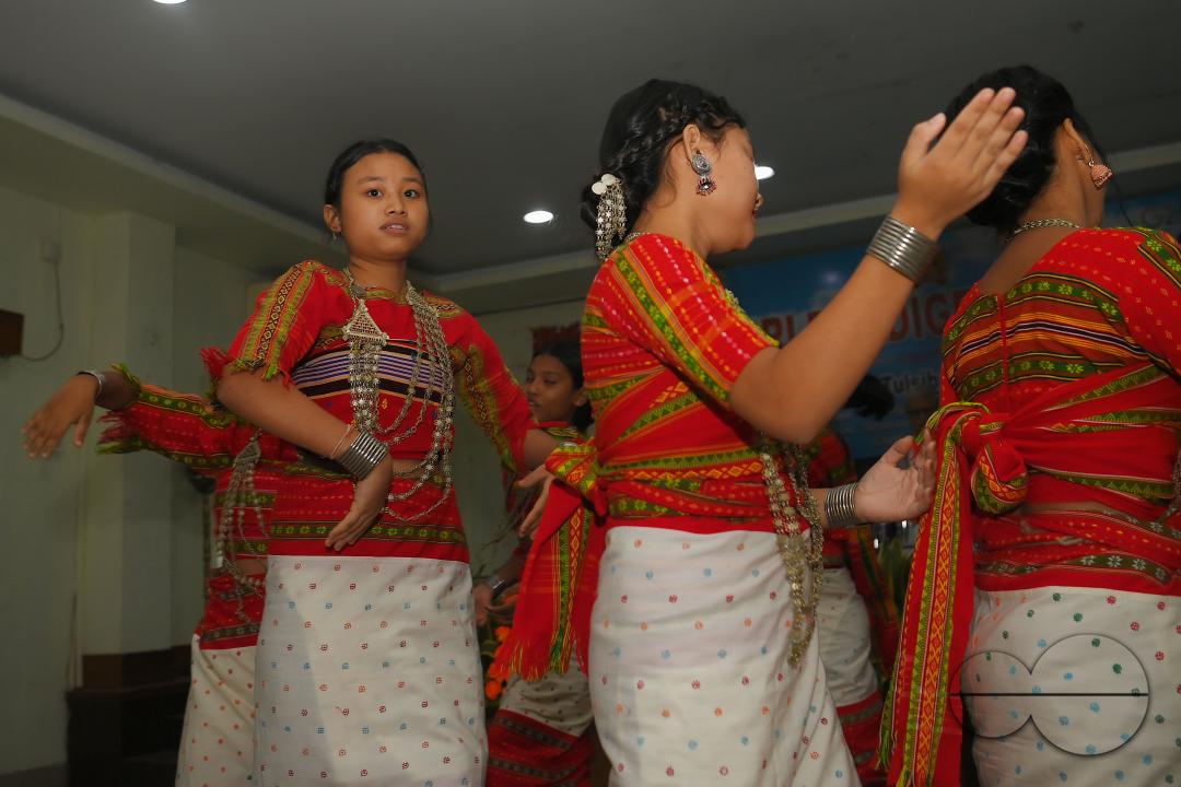 Indigenous girls perform traditional dances on the occasion of World Indigenous Day in an auditorium at Agartala
