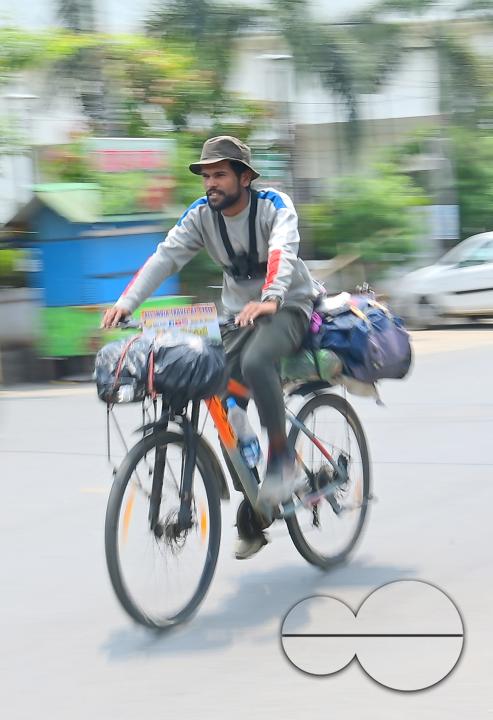 Sampoorn Shukla, a 23-year old Radio Jockey from Ashiyana, Lucknow, seen riding a bicycle during his India tour with the theme âJoin humanity save nature," in Agartala