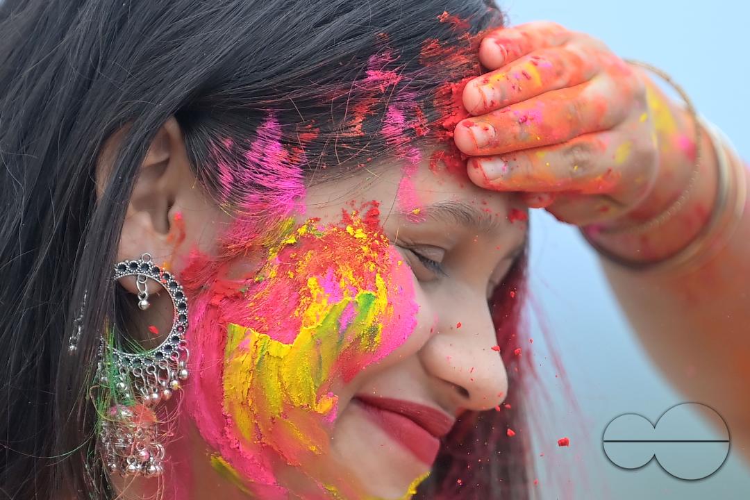 Indian girls adorned with 'Gulal' or coloured powder during the Hindu spring festival 'Holi', the festival of colour in Agartala