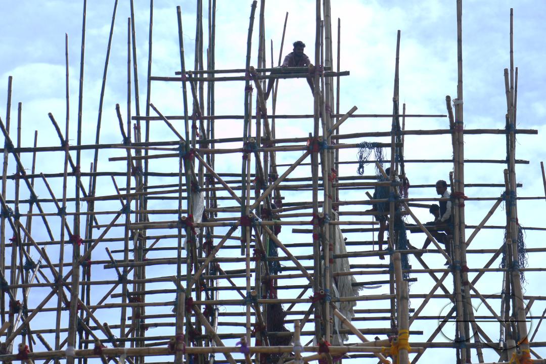Workers are making a temporary bamboo structure, locally called "Pandal", for the upcoming Durga Puja in Agartala