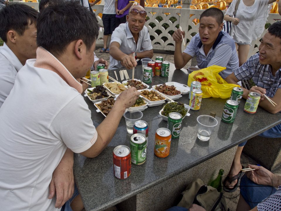 Colleagues from office having lunch in Chinatown on the eve of Chinese New Year in Singapore