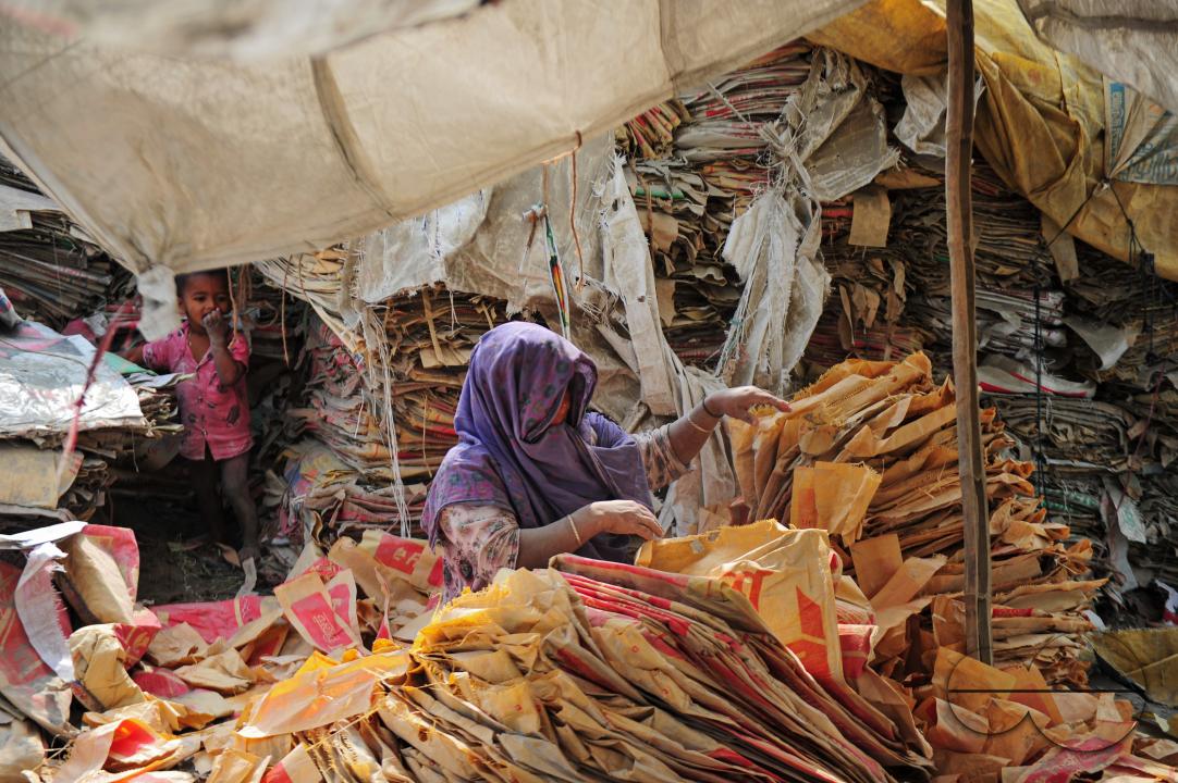 Women are risking their lives to wash cement bags beside the Surma River in Sylhet