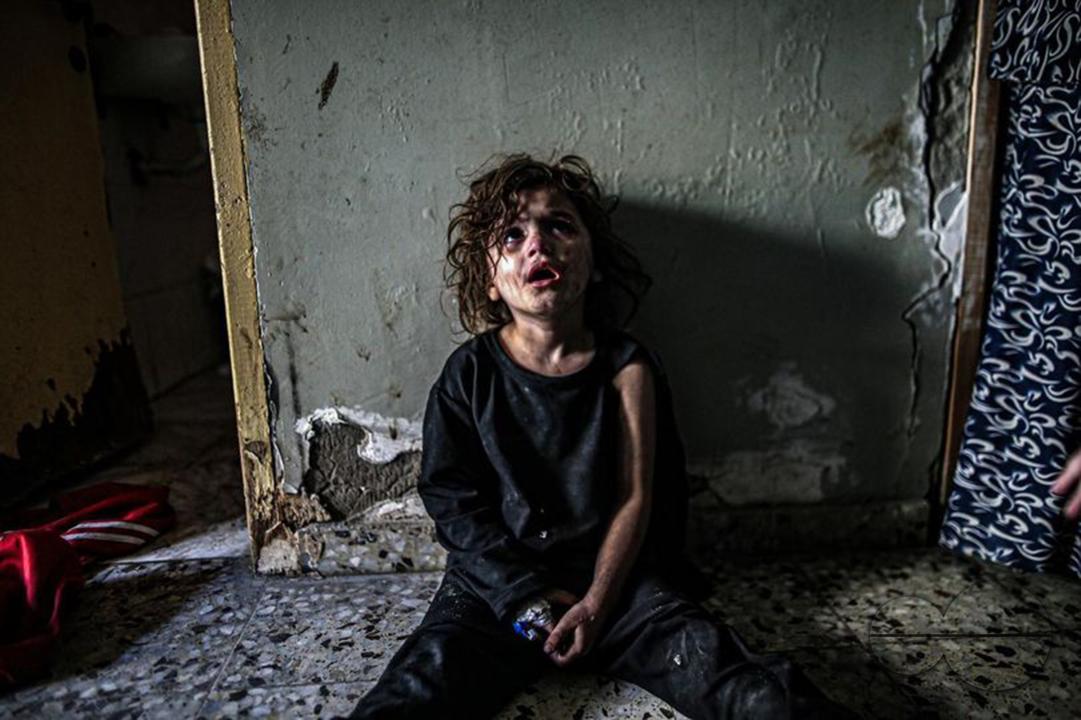 A Palestinian girl lost her family after her house was bombed by Israel Air attacks