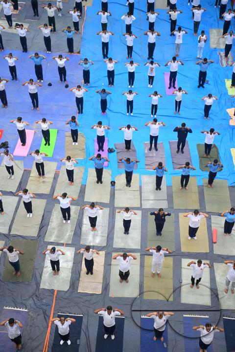 NCC cadets and officials perform yoga during 10th International Day of Yoga Day at BBM College Ground in Agartala