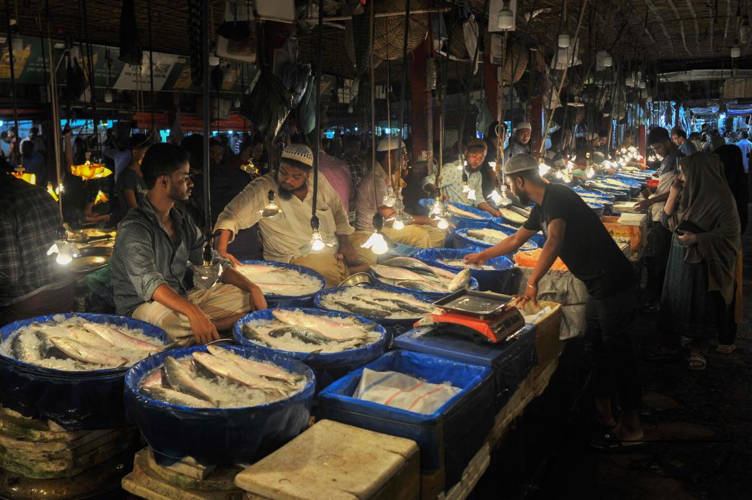 People buy Hilsa fish at the Lalbazar fish market in Sylhet city