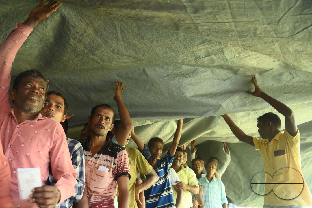 Voters wait in a queue to cast their votes during the by-elections for the Boxonagar assembly seat, in Tripura Sepahijala district