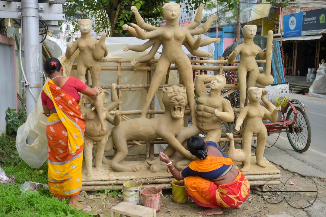 Idol makers adding finishing touches to an idol of the Mother Goddess Durga in a studio, ahead of the Durga Puja festival in Agartala, Tripura, India.