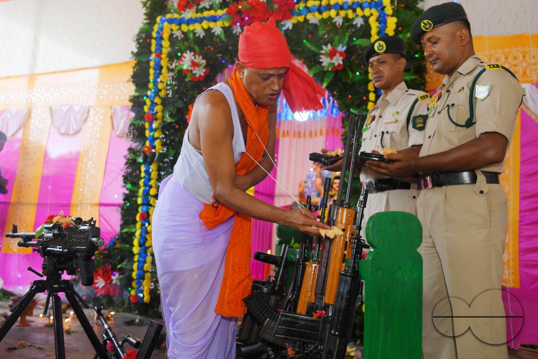 A priest performs worship of arms on Vishwakarma Puja in a TSR (Tripura State Rifles) camp on the outskirts of Agartala