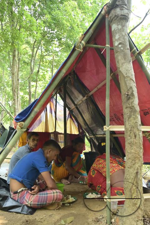People in makeshift tents at Panisagar's reserve forest area