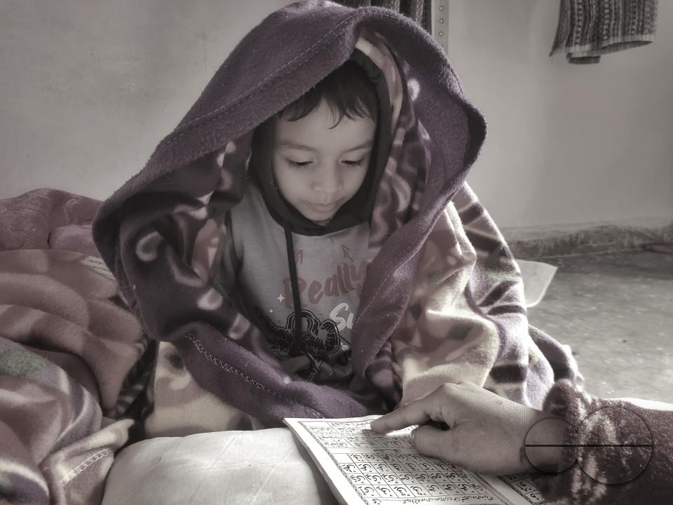 A child learning to read at the Balukhali refugee camp