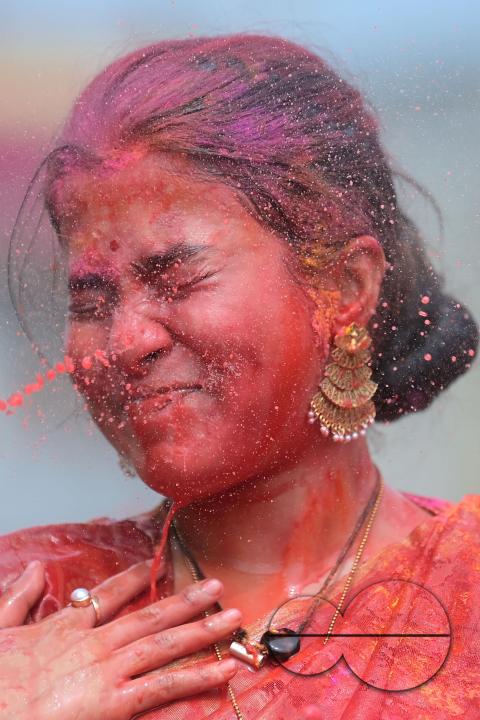 Indian girls adorned with 'Gulal' or coloured powder during the Hindu spring festival 'Holi', the festival of colour in Agartala