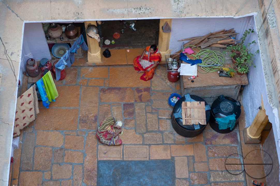 Women going about daily activities in a haveli in Jaisalmer.