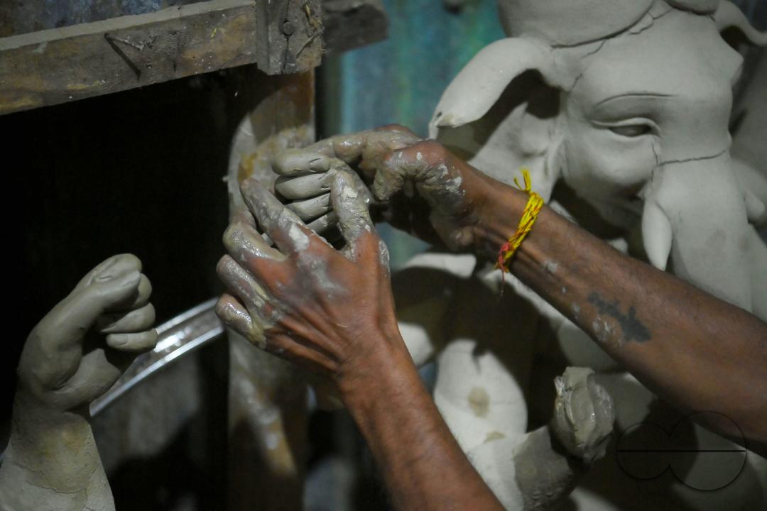 An Idol maker making idols of Lord Ganesh in a studio for the upcoming Ganesh Chaturthi festival at Agartala
