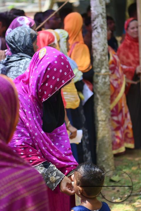 Muslim voters patiently await their turn to cast their votes at a Boxanagar polling station in Agartala in the first phase of Lok Sabha elections
